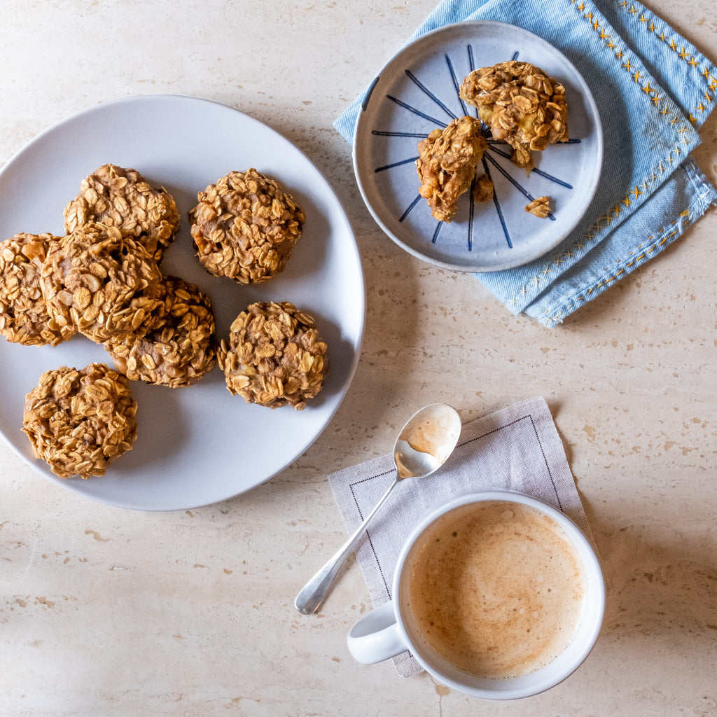 A plate of Banana oatmeal cookies with cup of latte