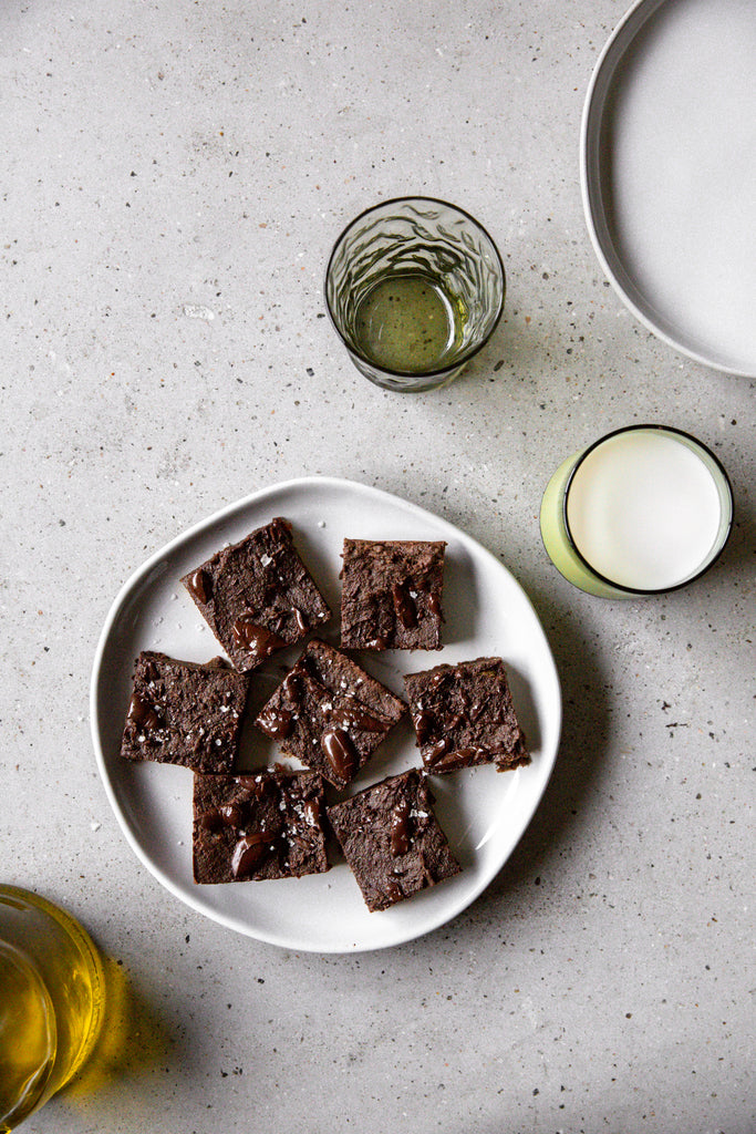 Fudge Date Brownies on a Plate Surrounded by Ingredients