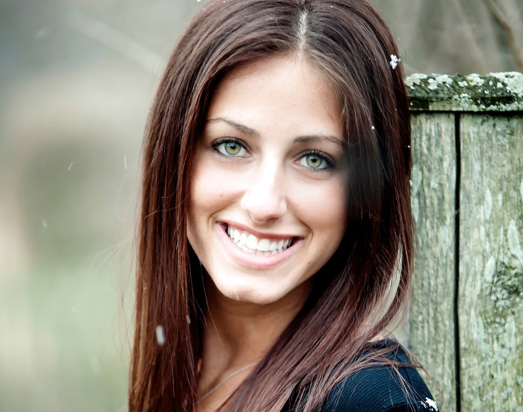 Michelle Rubinstein smiling with a rustic background