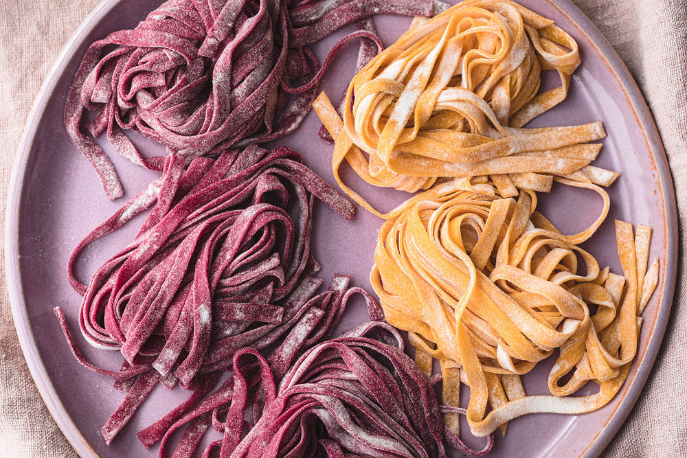 top view of beet and carrots pasta on plate