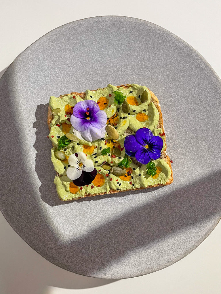 A Piece of Toast Smeared with a Spread made From the Organic Apples Green Blend Decorated with Editable Flowers 