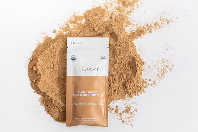 Golden Banana Blend Powder Spread Out with the Tejari Sachet Laying in the On Top