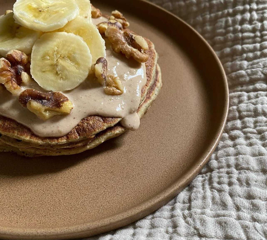 Pancakes with Cashew and Banana on Top Set on Appetizing Breakfast Plate