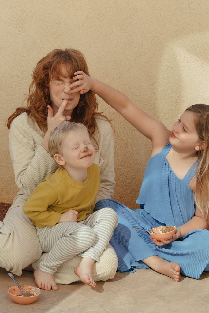 Mom Daughter and Son Putting Organic Cacao on each others  Noses